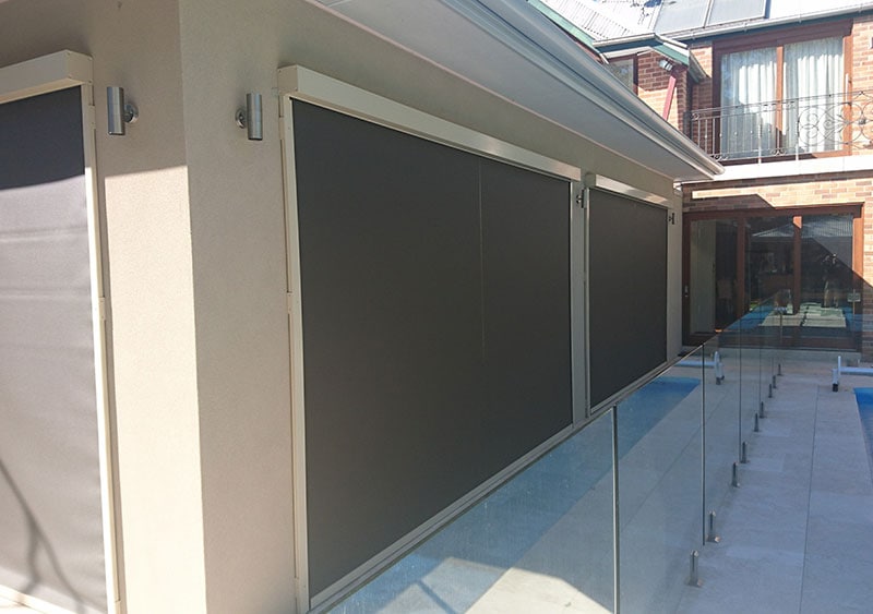 A home's rear view with all of the blinds drawn.