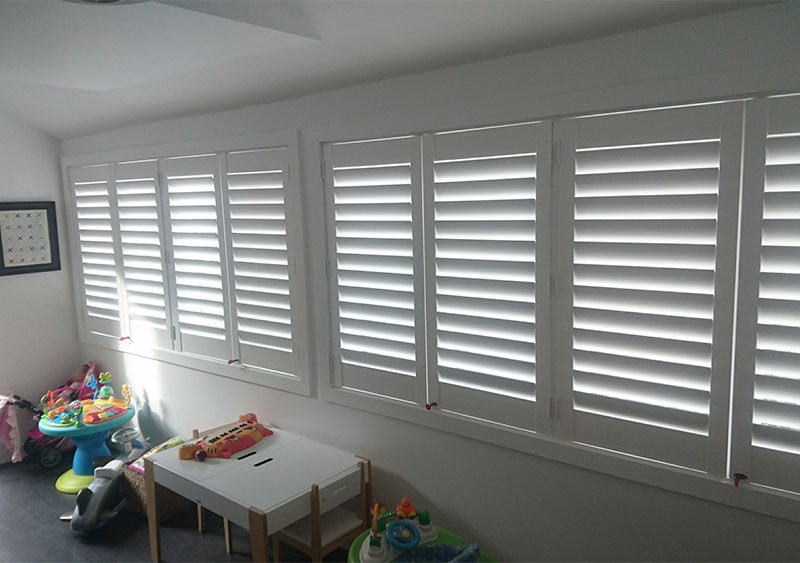 Inside view of a white house with closed plantation shutters