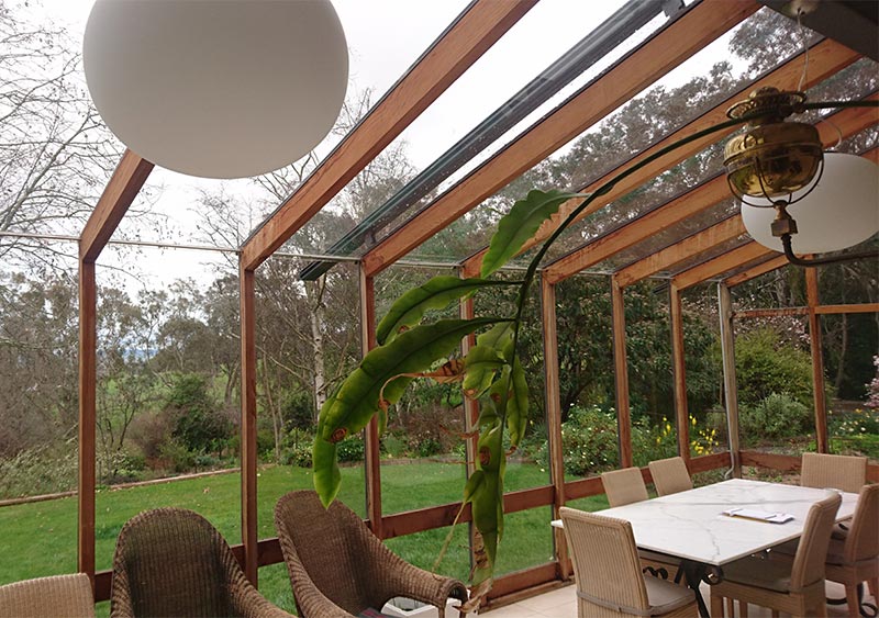 A patio built-in wooden style with comfy chairs and table