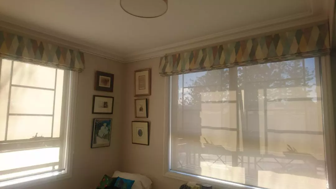 Translucent blinds and a folded colorful roman blinds